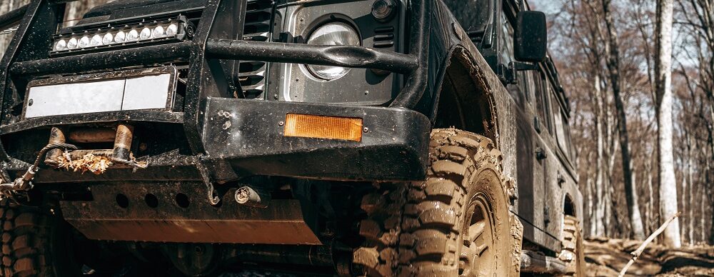 Dirty off road car on trip in forest close up