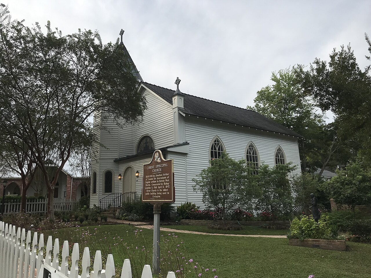Christ Episcopal Church in Covington, a white wooden chapel behind a historical marker and picket fence